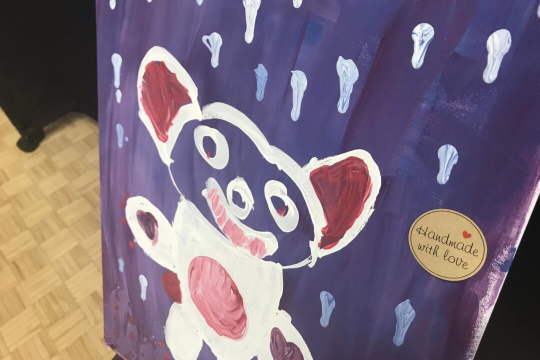 A handmade painting of a stylized panda with "handmade with love" sticker.
