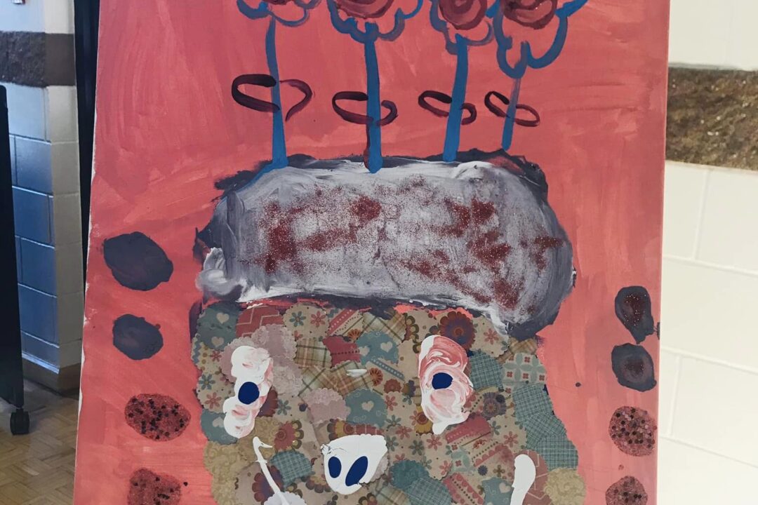 Child's mixed-media artwork featuring flowers and abstract patterns on a red background displayed on an easel.